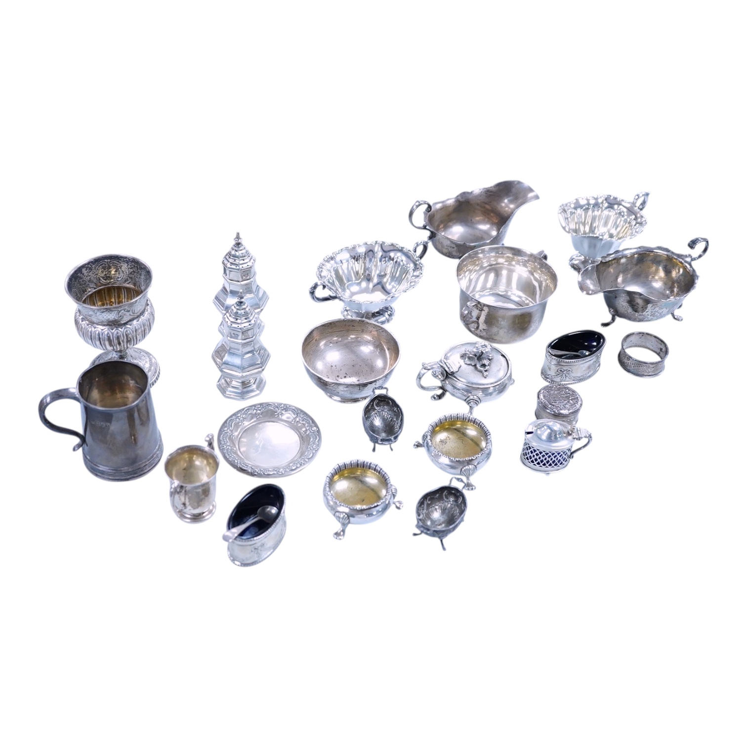A collection of small silver wares to include a George V silver porringer, two George V silver sauce boats, a let Victorian silver sugar bowl, a George III silver goblet, with later embossed decoration, a George V small